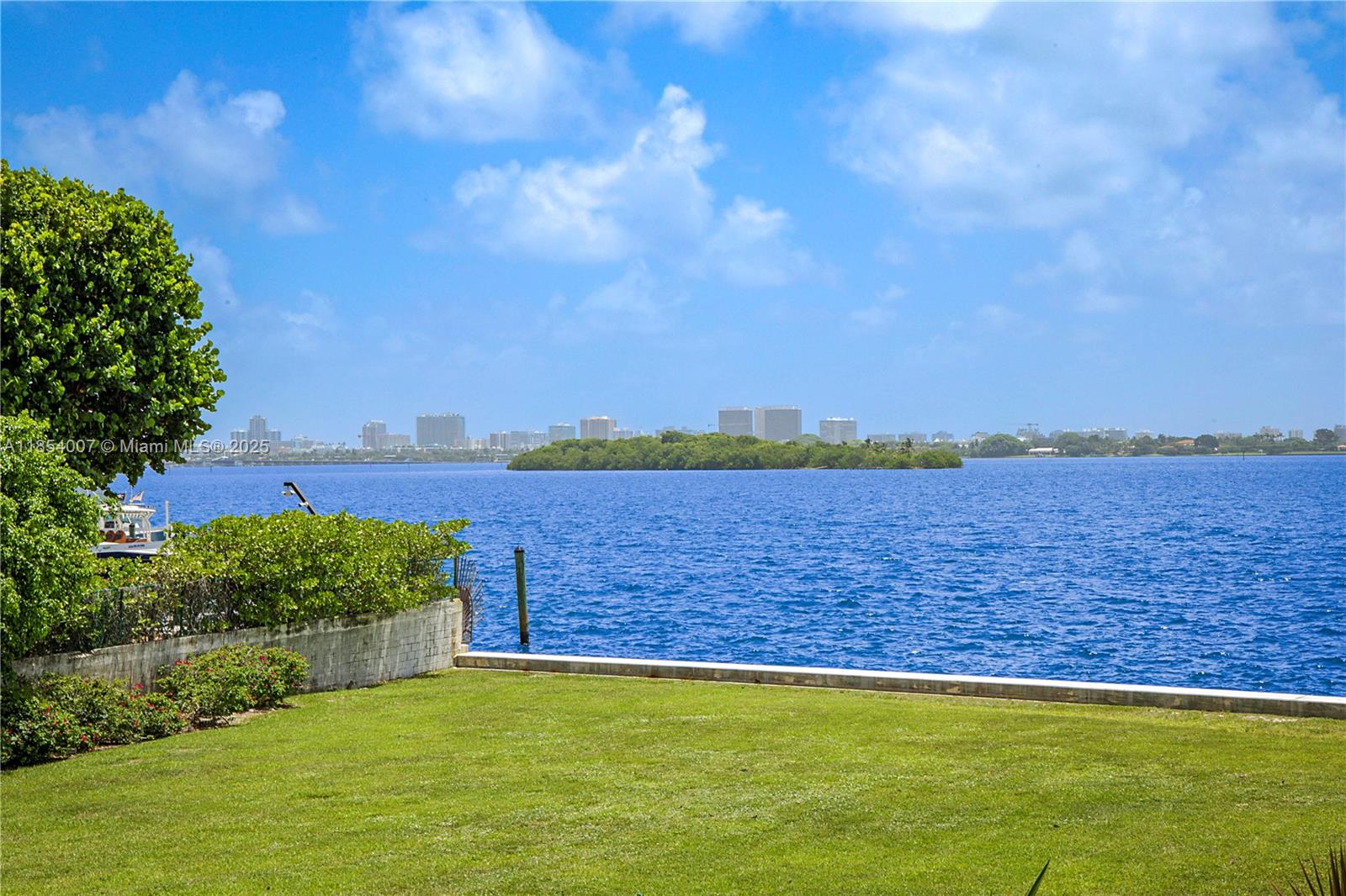 1700 Northeast 105th Street, Unit 203 Miami Shores, FL 33138 - Photo 32 of 45 a view of a ocean with a large building in the background