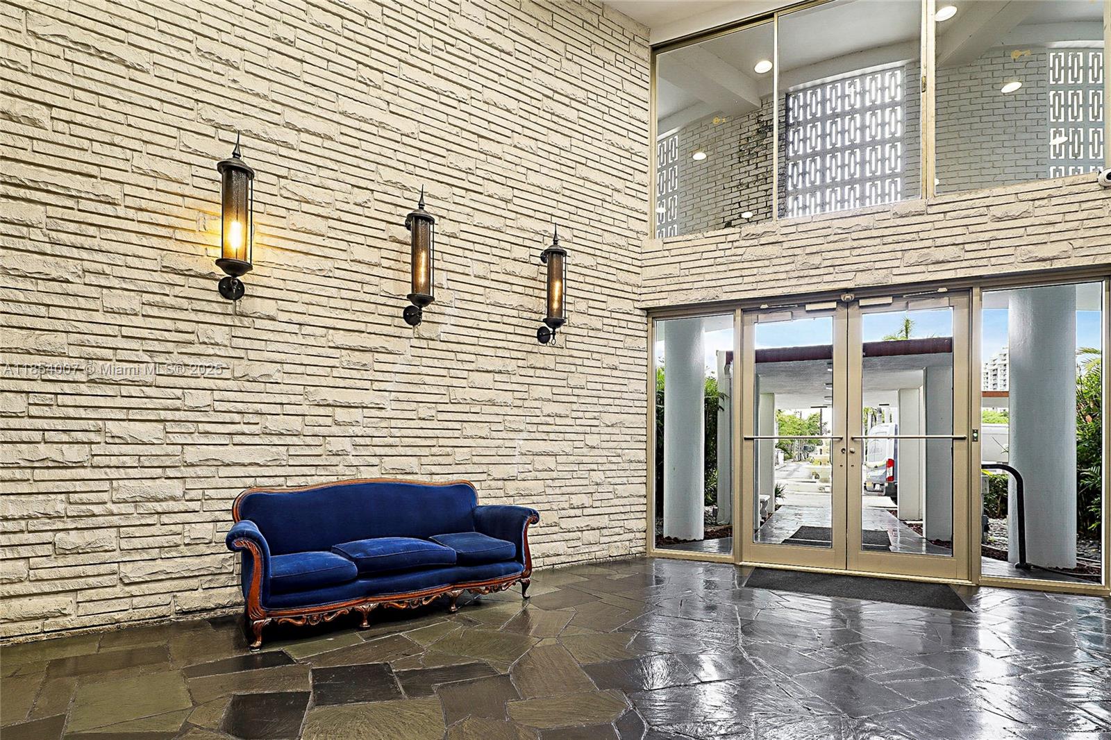 1700 Northeast 105th Street, Unit 203 Miami Shores, FL 33138 - Photo 35 of 45 a view of a chairs with a table in patio