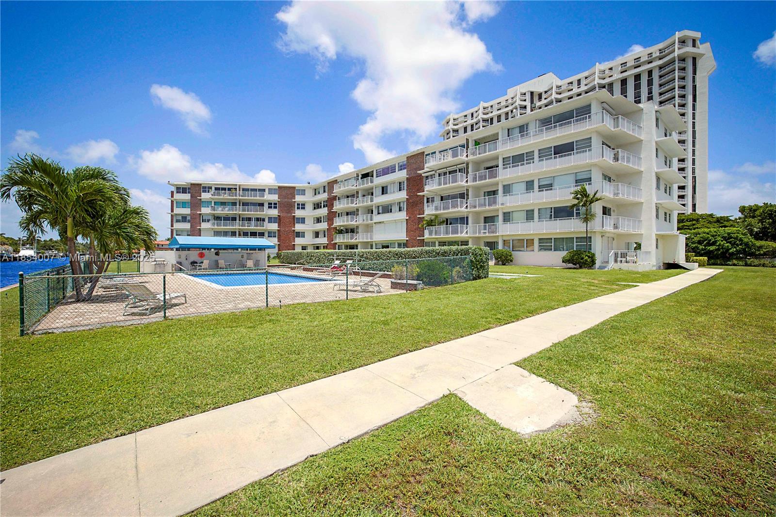 1700 Northeast 105th Street, Unit 203 Miami Shores, FL 33138 - Photo 38 of 45 a view of a building with a big yard and plants