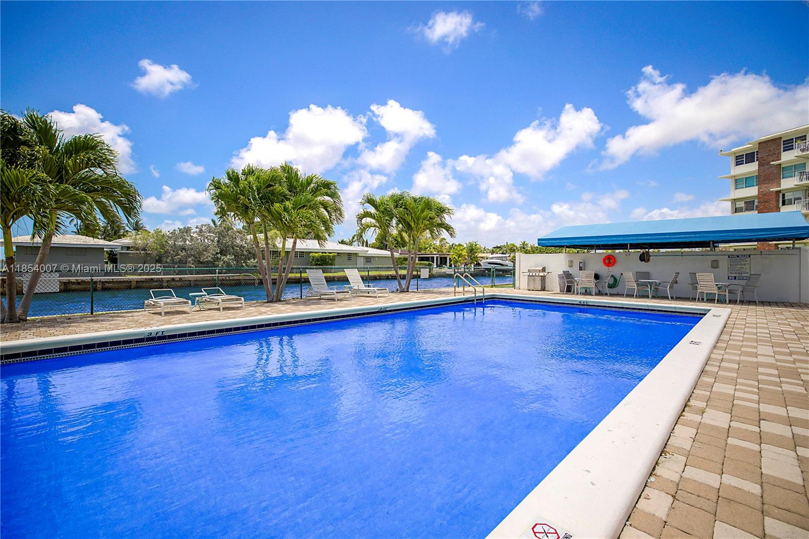 1700 Northeast 105th Street, Unit 203 Miami Shores, FL 33138 - Photo 43 of 45 a view of swimming pool with outdoor seating