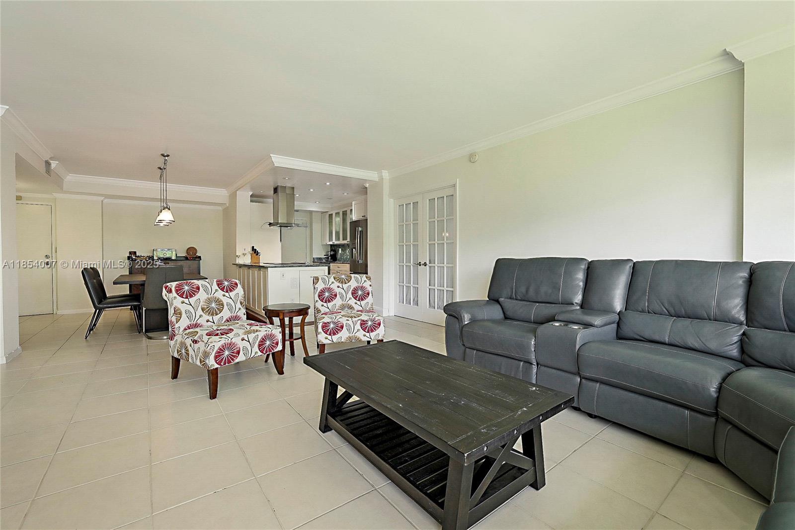 1700 Northeast 105th Street, Unit 203 Miami Shores, FL 33138 - Photo 5 of 45 a living room with furniture and a couch
