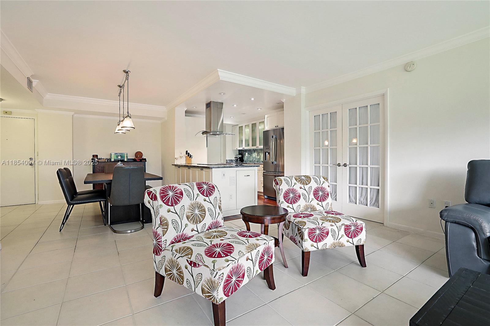 1700 Northeast 105th Street, Unit 203 Miami Shores, FL 33138 - Photo 6 of 45 a living room with furniture and flat screen tv