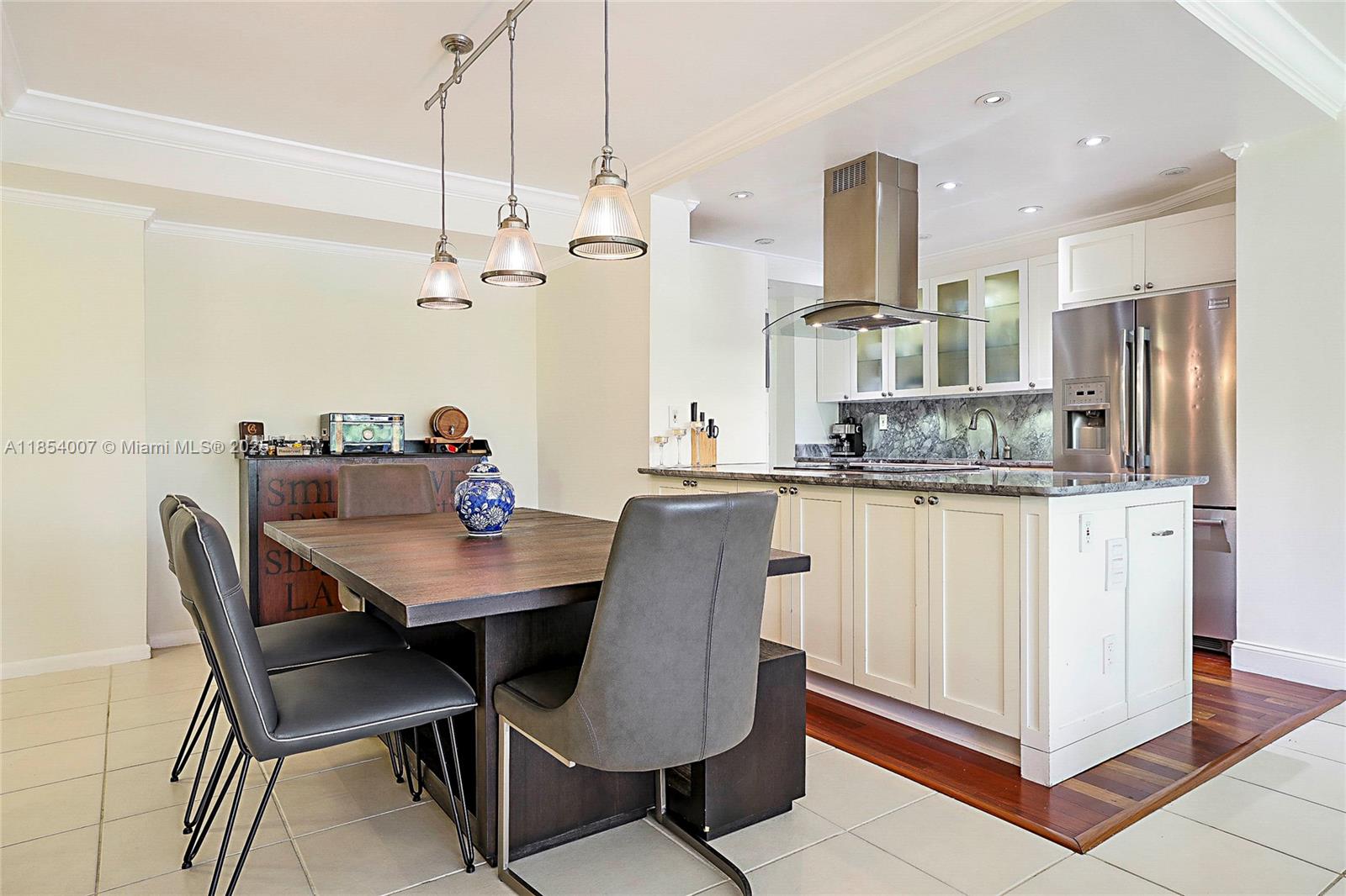 1700 Northeast 105th Street, Unit 203 Miami Shores, FL 33138 - Photo 7 of 45 a dining room with furniture and window