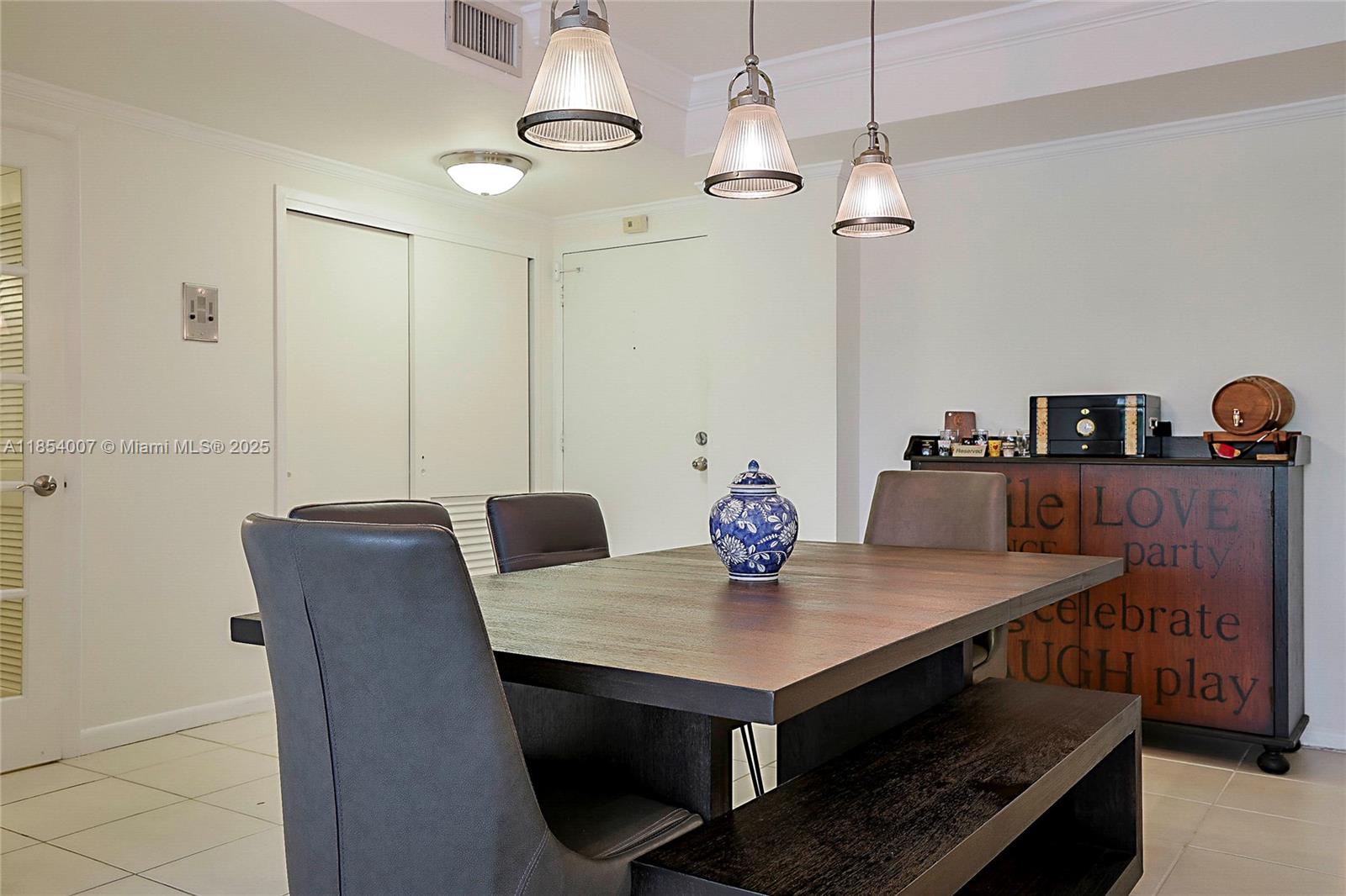 1700 Northeast 105th Street, Unit 203 Miami Shores, FL 33138 - Photo 8 of 45 a view of a dining room with furniture