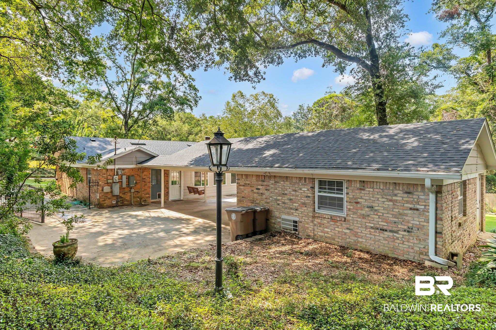 309 West Brandy Run Road Mobile, AL 36608 - Photo 78 of 100 Back of house featuring a patio area, roof with shingles, brick siding, and a chimney