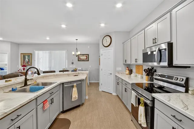a bathroom with double vanity sinks a vanity and a large mirror