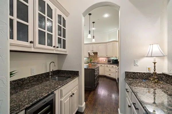 a kitchen with stainless steel appliances granite countertop a sink stove and cabinets