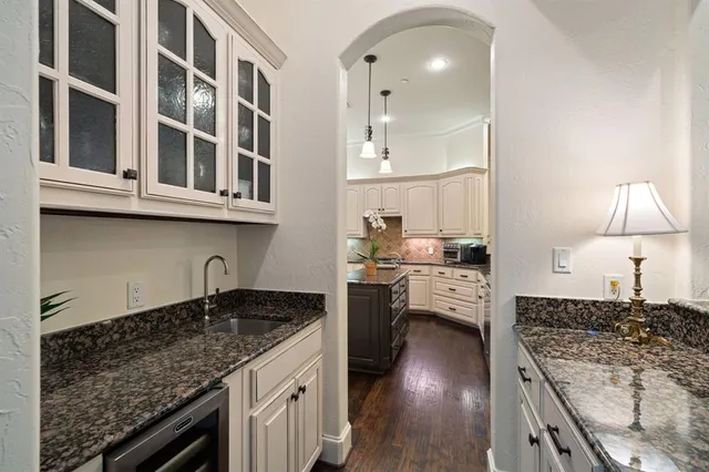 a kitchen with stainless steel appliances granite countertop a sink stove and cabinets