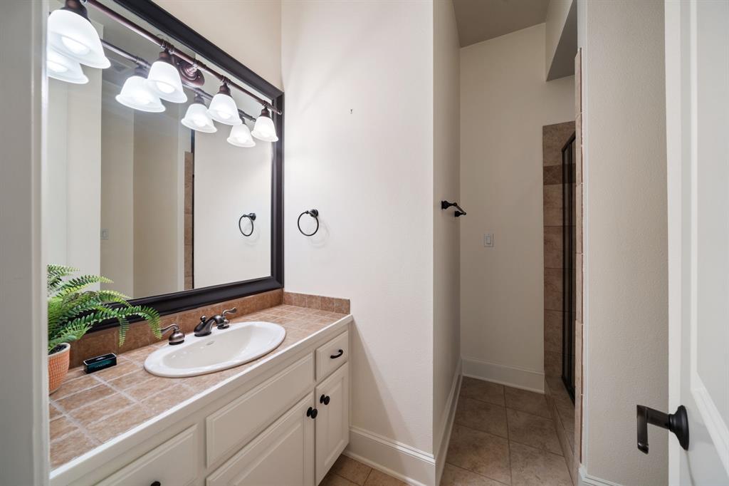 34 Piazza Lane Colleyville, TX 76034 - Photo 23 of 38 a bathroom with a granite countertop sink and a mirror
