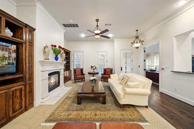 a living room with furniture a fireplace and a flat screen tv