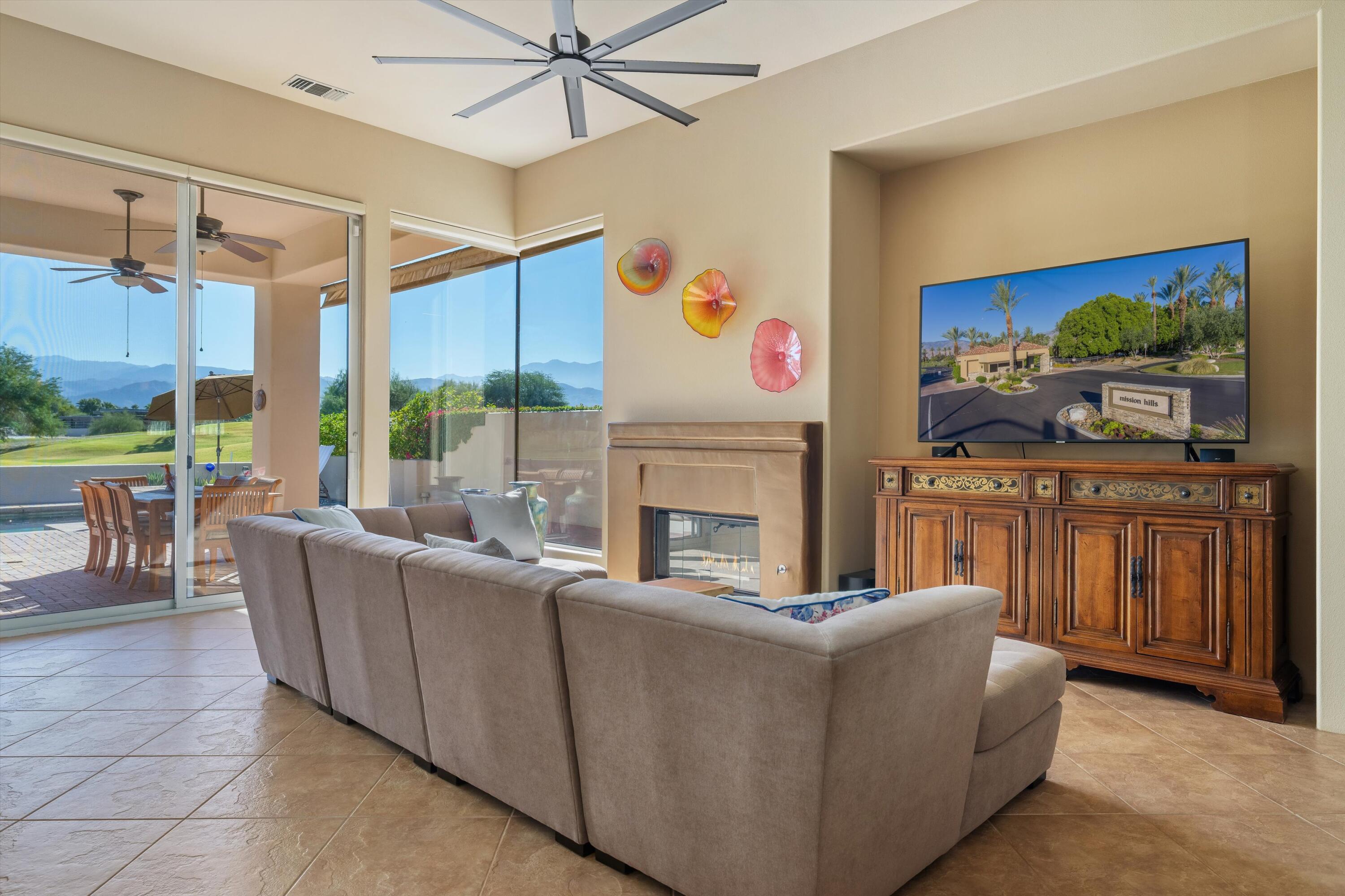 270 Loch Lomond Road Rancho Mirage, CA 92270 - Photo 11 of 51 a living room with furniture a fireplace and a flat screen tv