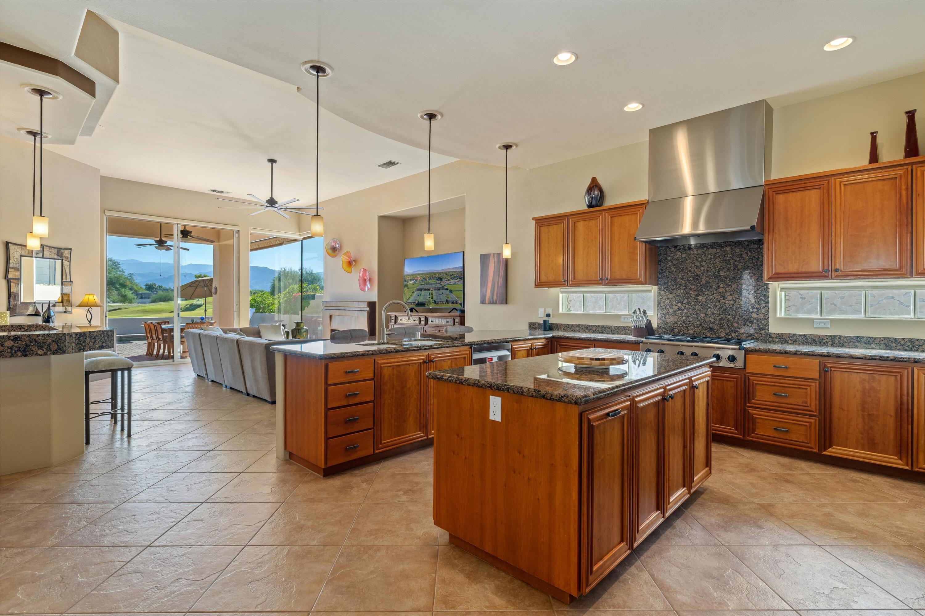 270 Loch Lomond Road Rancho Mirage, CA 92270 - Photo 16 of 51 a kitchen with stainless steel appliances granite countertop a stove a sink and a refrigerator