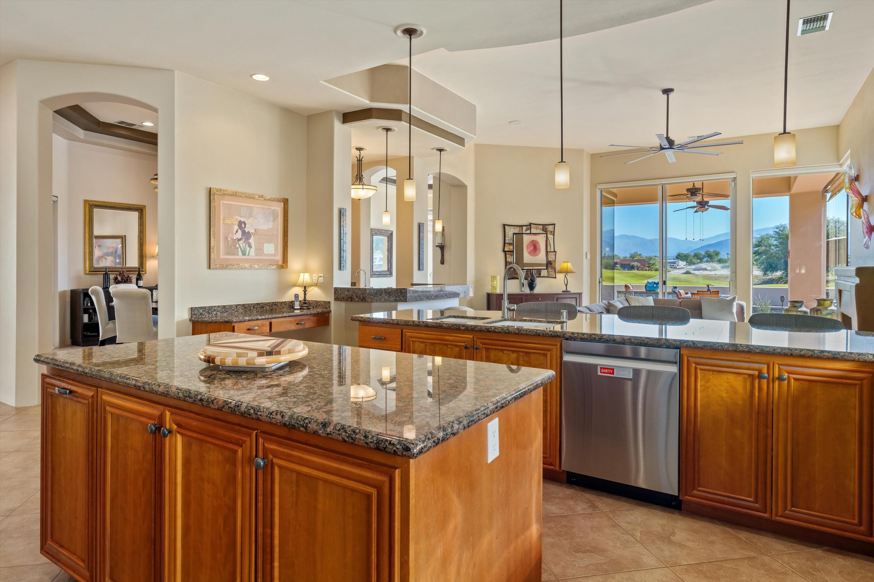 270 Loch Lomond Road Rancho Mirage, CA 92270 - Photo 17 of 51 a kitchen with stainless steel appliances granite countertop a sink and a counter space