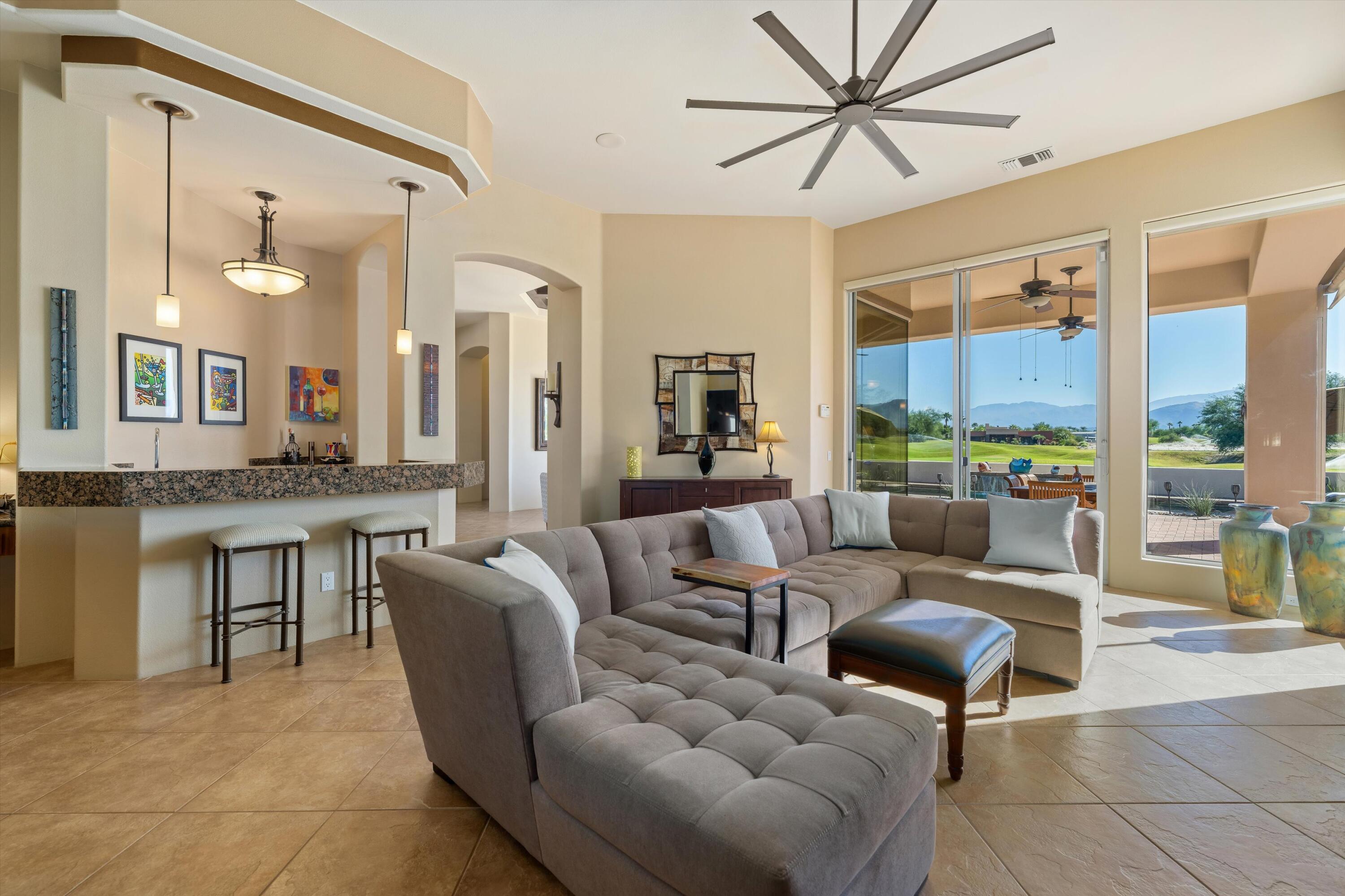 270 Loch Lomond Road Rancho Mirage, CA 92270 - Photo 18 of 51 a living room with furniture a large window and a chandelier