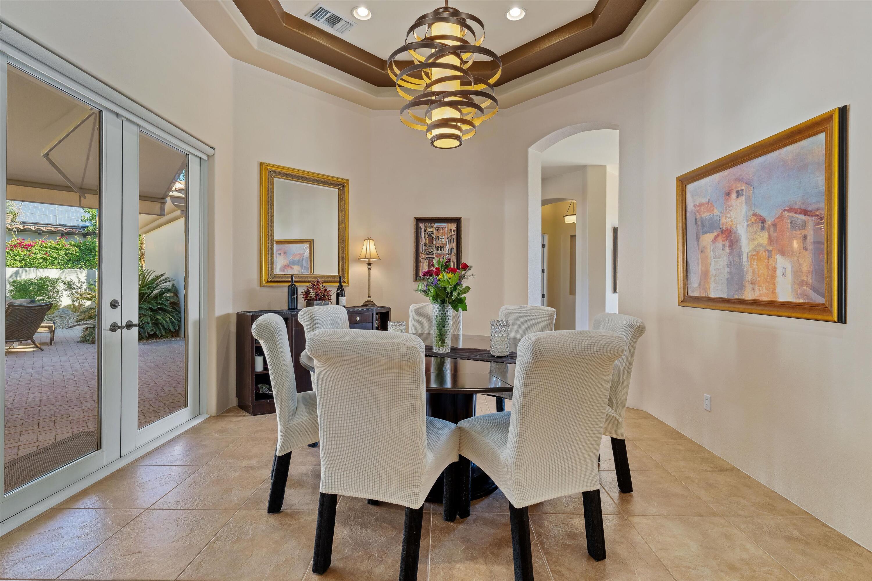 270 Loch Lomond Road Rancho Mirage, CA 92270 - Photo 19 of 51 a view of a dining room with furniture and a chandelier