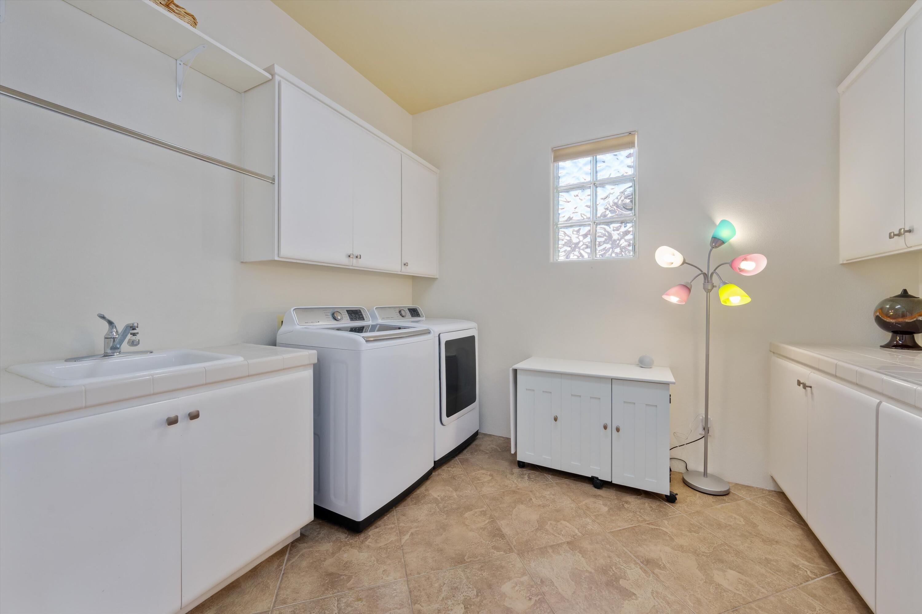 270 Loch Lomond Road Rancho Mirage, CA 92270 - Photo 20 of 51 a utility room with cabinets washer and dryer