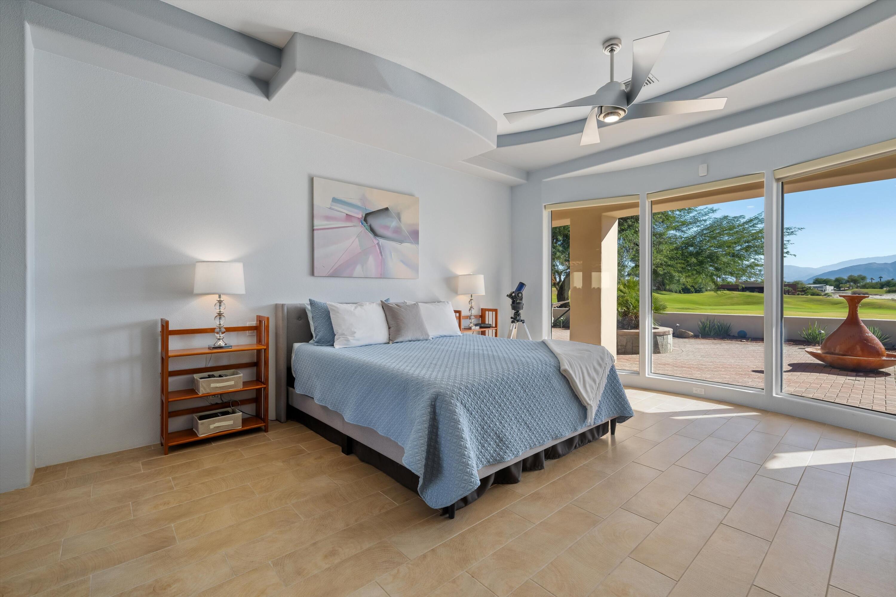 270 Loch Lomond Road Rancho Mirage, CA 92270 - Photo 23 of 51 a spacious bedroom with a bed and a large window