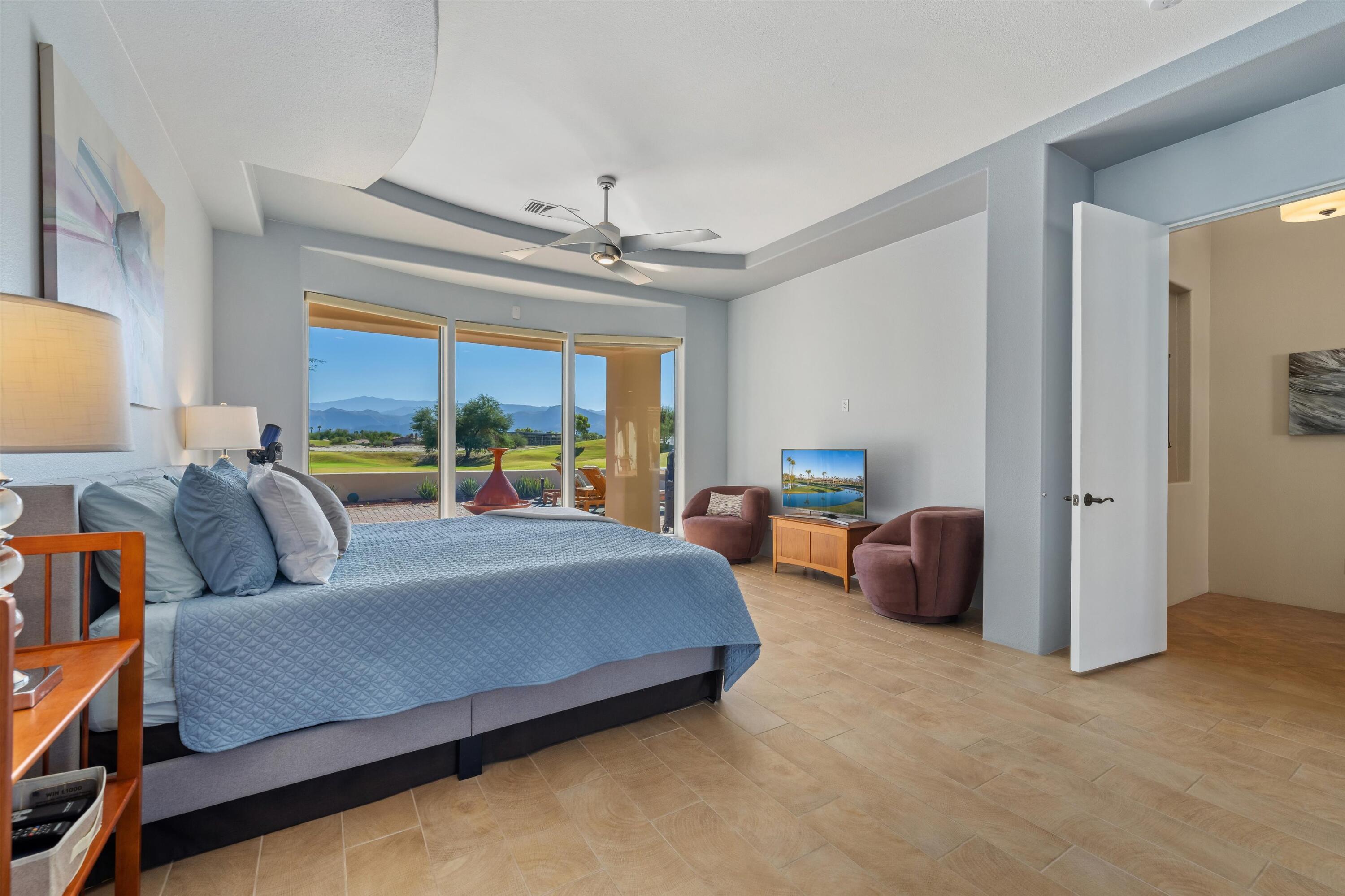 270 Loch Lomond Road Rancho Mirage, CA 92270 - Photo 28 of 51 a bedroom with a bed and a chandelier