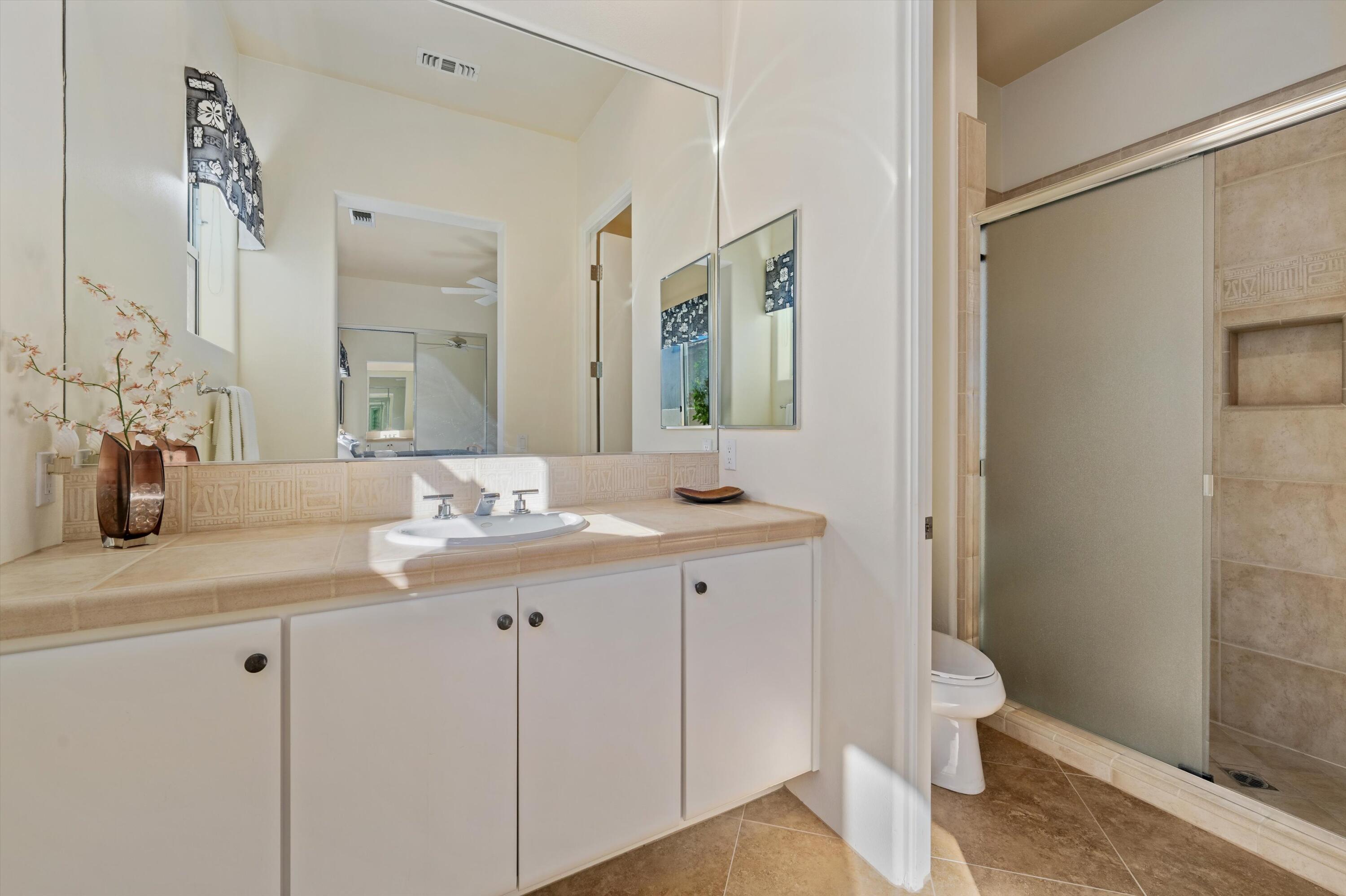270 Loch Lomond Road Rancho Mirage, CA 92270 - Photo 29 of 51 a bathroom with a granite countertop sink a toilet and a mirror