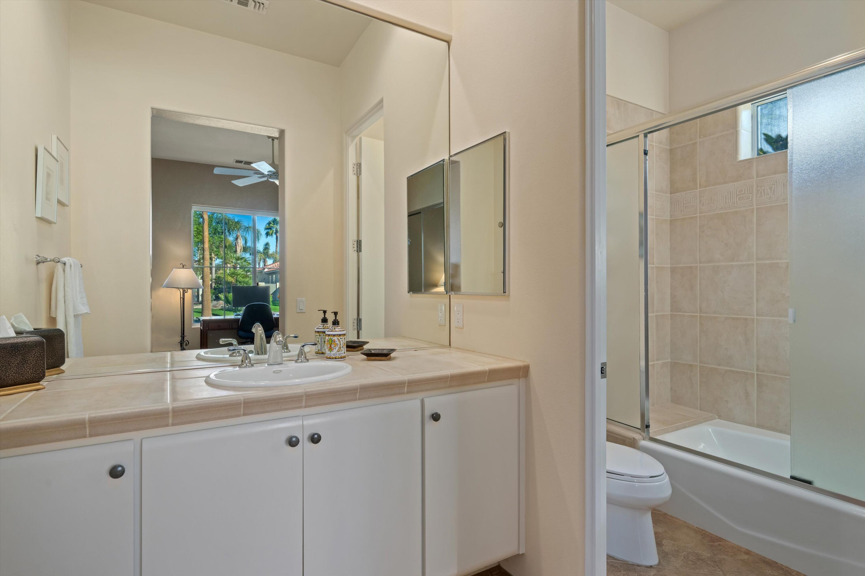 270 Loch Lomond Road Rancho Mirage, CA 92270 - Photo 31 of 51 a bathroom with a granite countertop sink toilet and shower