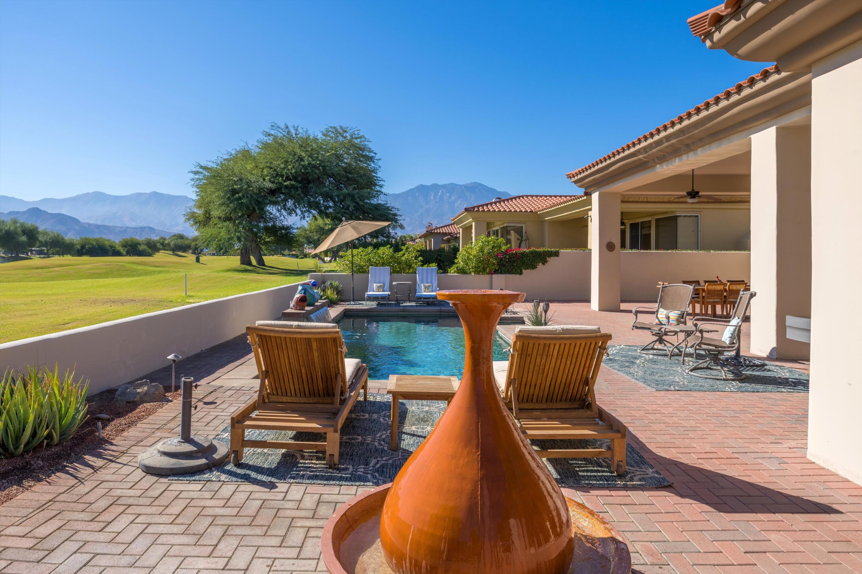 270 Loch Lomond Road Rancho Mirage, CA 92270 - Photo 40 of 51 a view of a chairs and table in patio