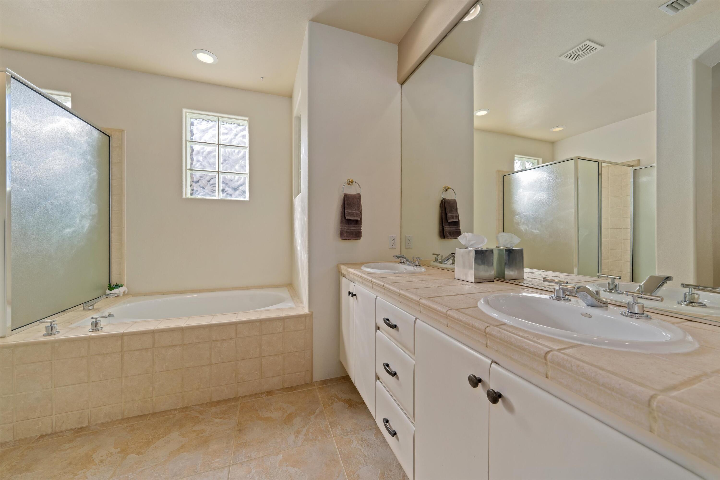 270 Loch Lomond Road Rancho Mirage, CA 92270 - Photo 50 of 51 a bathroom with a double vanity sink a mirror and a bathtub