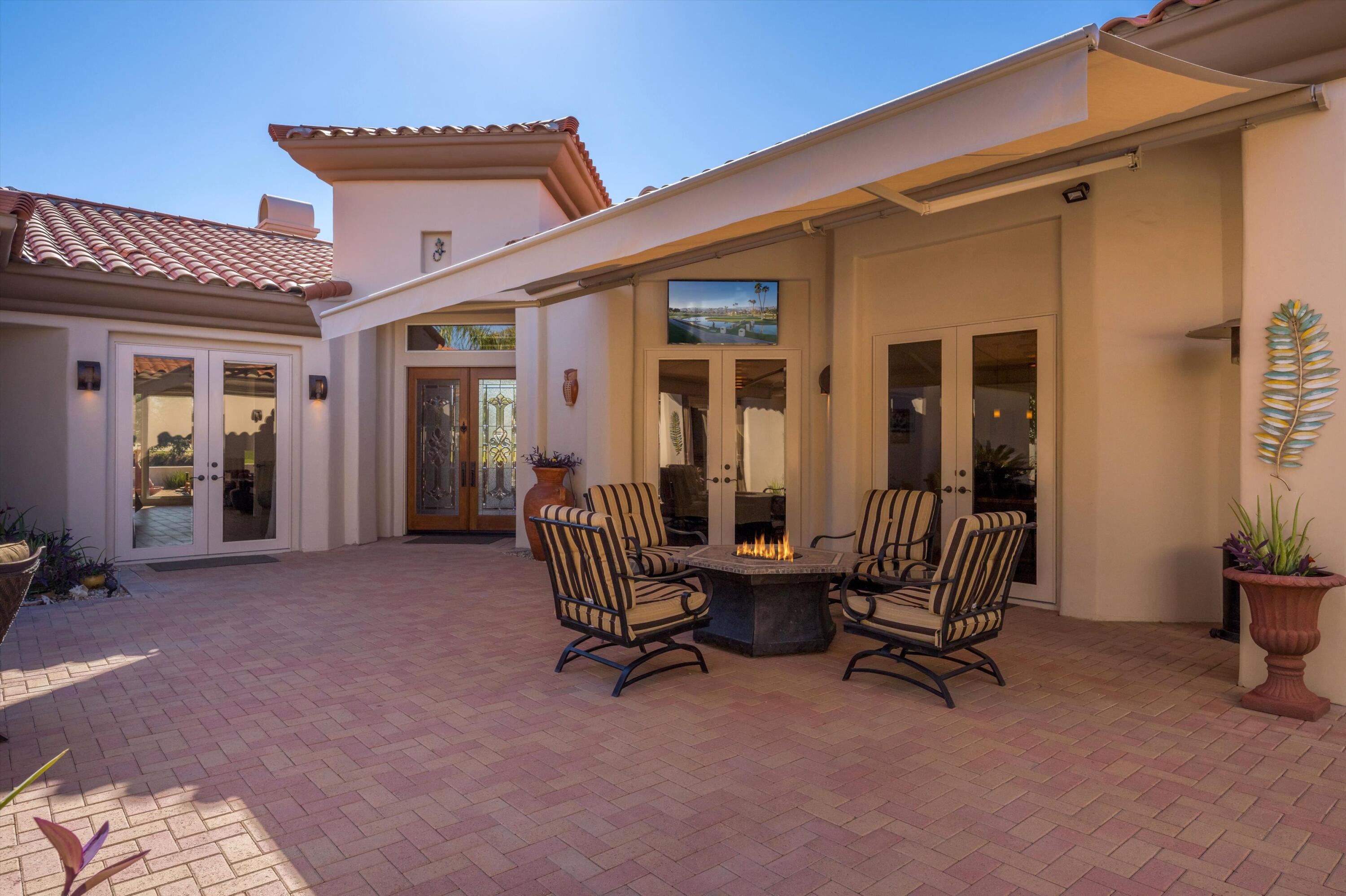 270 Loch Lomond Road Rancho Mirage, CA 92270 - Photo 5 of 51 a view of a patio with table and chairs