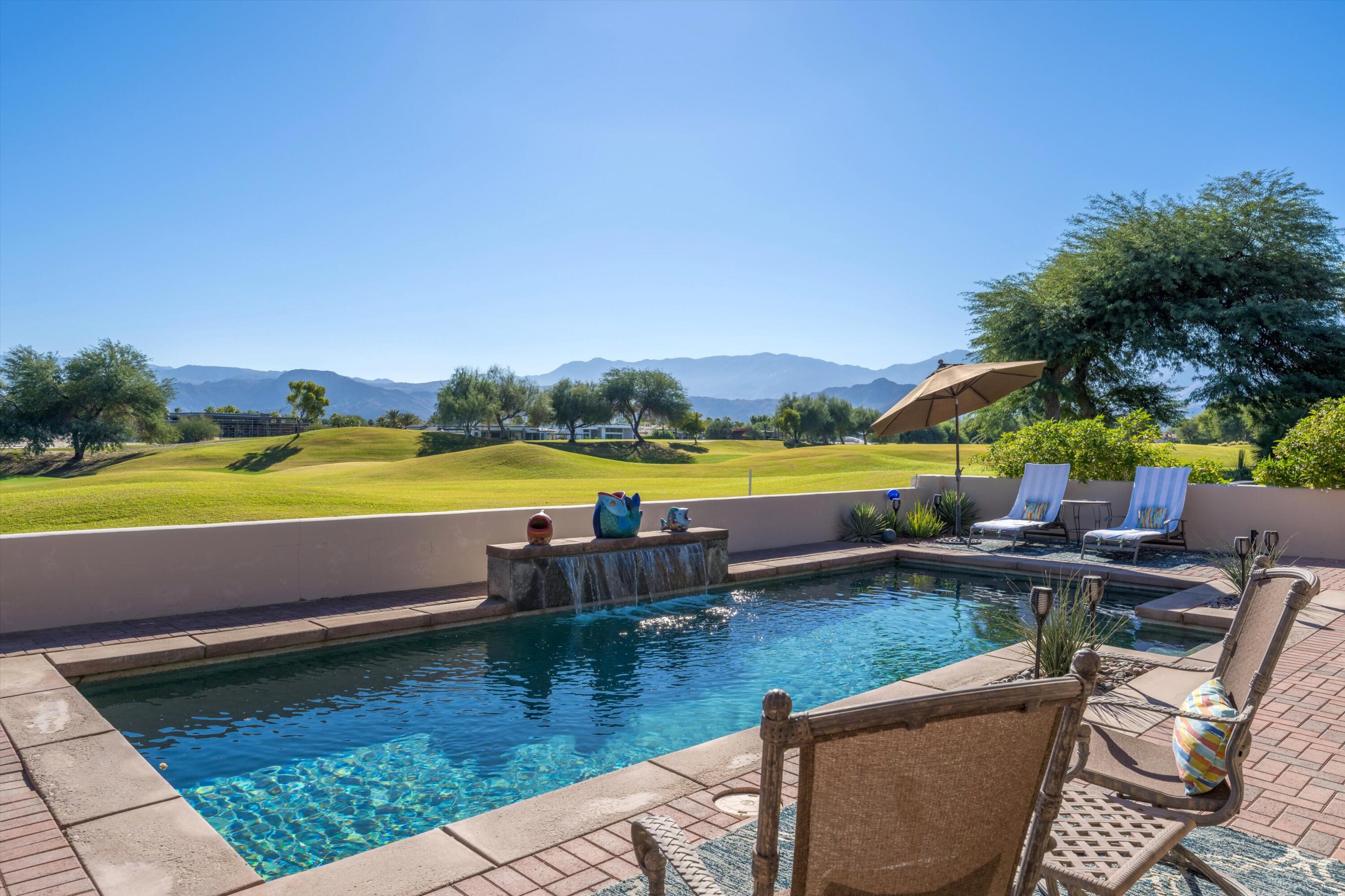 270 Loch Lomond Road Rancho Mirage, CA 92270 - Photo 51 of 51 a view of a swimming pool with an outdoor seating and yard