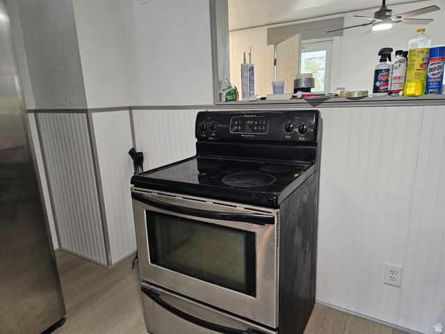 744 Royal Street Helper, UT 84526 - Photo 13 of 33 Kitchen with stainless steel appliances, light wood-type flooring, ceiling fan, and a textured wall