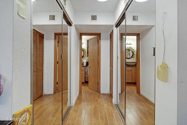 a view of a hallway with wooden floor and glass door