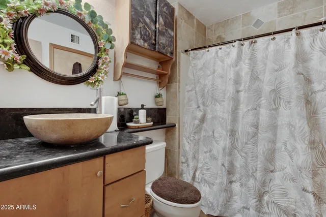a view of a kitchen with a sink and a mirror