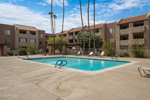a view of a patio with a table chairs and a fire pit