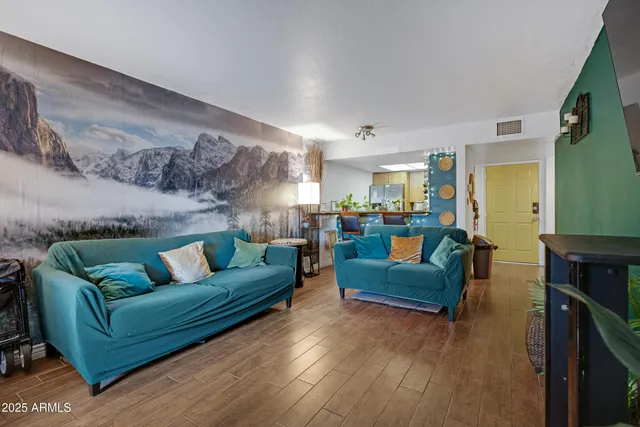 a living room with furniture and a wooden floor