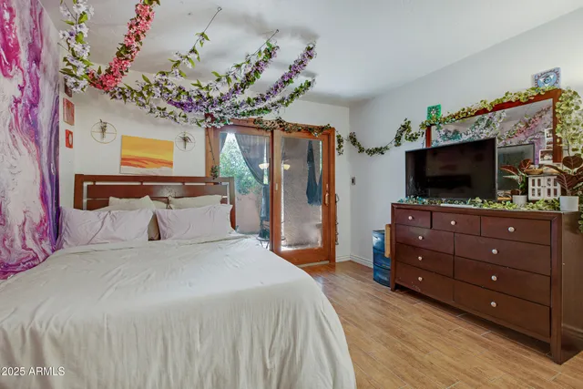 a bedroom with a bed and flat screen tv
