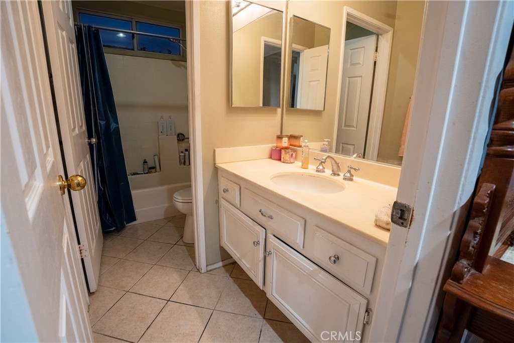 21329 Tennyson Road Moreno Valley, CA 92557 - Photo 12 of 32 a bathroom with a sink a mirror and a shower