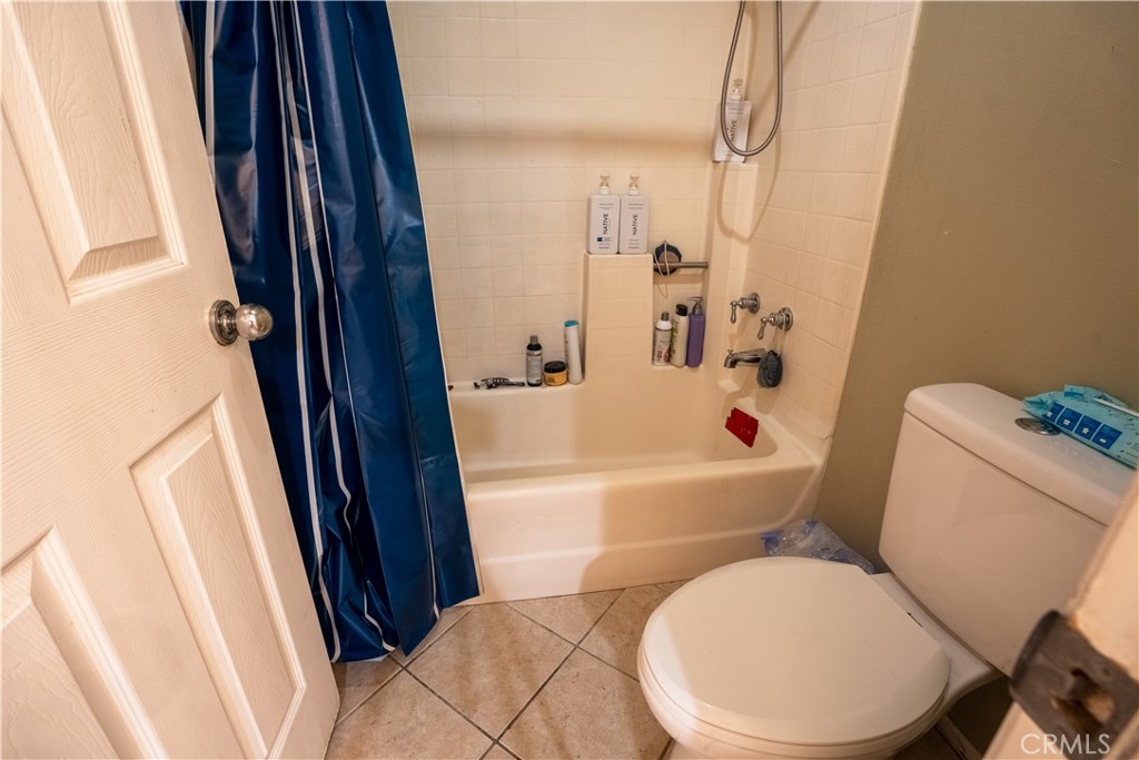 21329 Tennyson Road Moreno Valley, CA 92557 - Photo 13 of 32 a white toilet sitting next to a bathroom sink