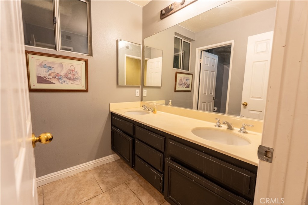 21329 Tennyson Road Moreno Valley, CA 92557 - Photo 21 of 32 a bathroom with a sink and a mirror