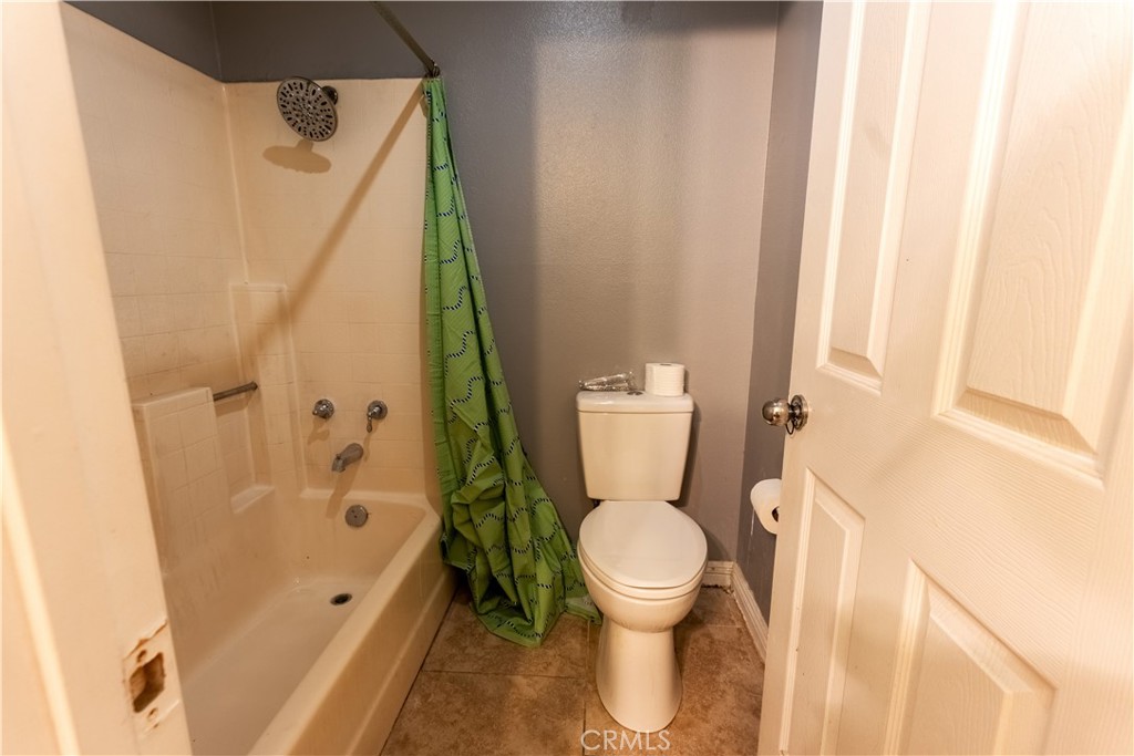 21329 Tennyson Road Moreno Valley, CA 92557 - Photo 22 of 32 a white toilet sitting next to a bath tub