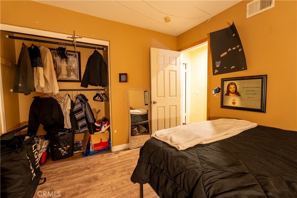 21329 Tennyson Road Moreno Valley, CA 92557 - Photo 24 of 32 a bedroom with a bed and a walk in closet