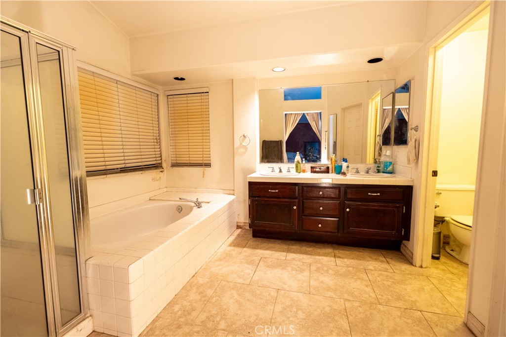 21329 Tennyson Road Moreno Valley, CA 92557 - Photo 27 of 32 a bathroom with a bathtub sink and mirror