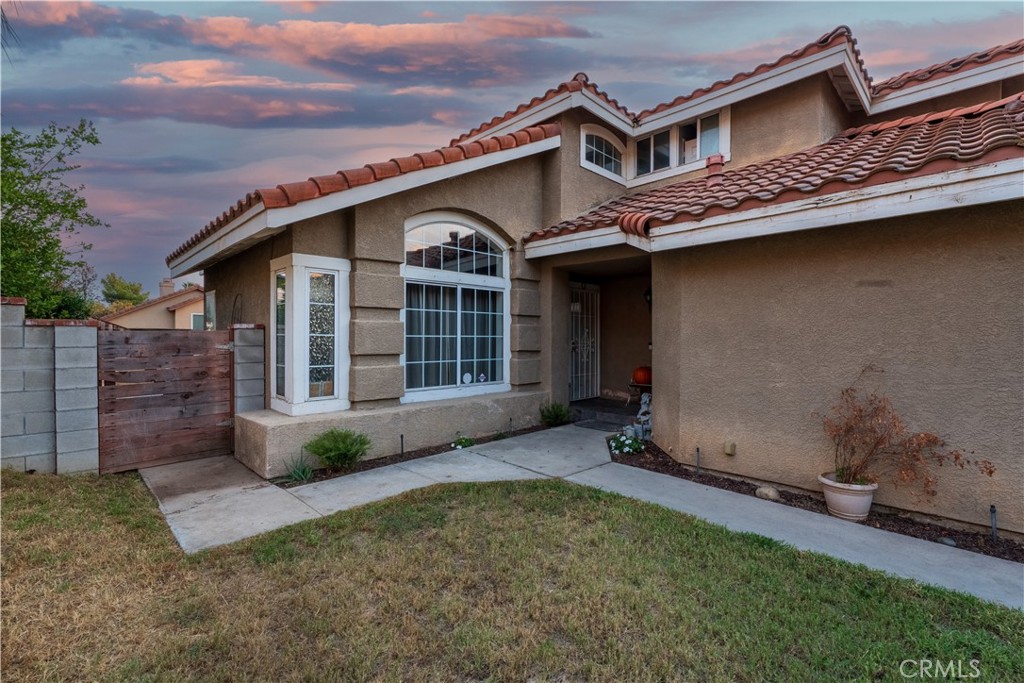 21329 Tennyson Road Moreno Valley, CA 92557 - Photo 4 of 32 front view of a house with a garden