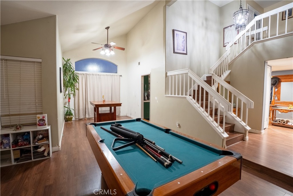 21329 Tennyson Road Moreno Valley, CA 92557 - Photo 6 of 32 a living room with furniture pool table and a chandelier