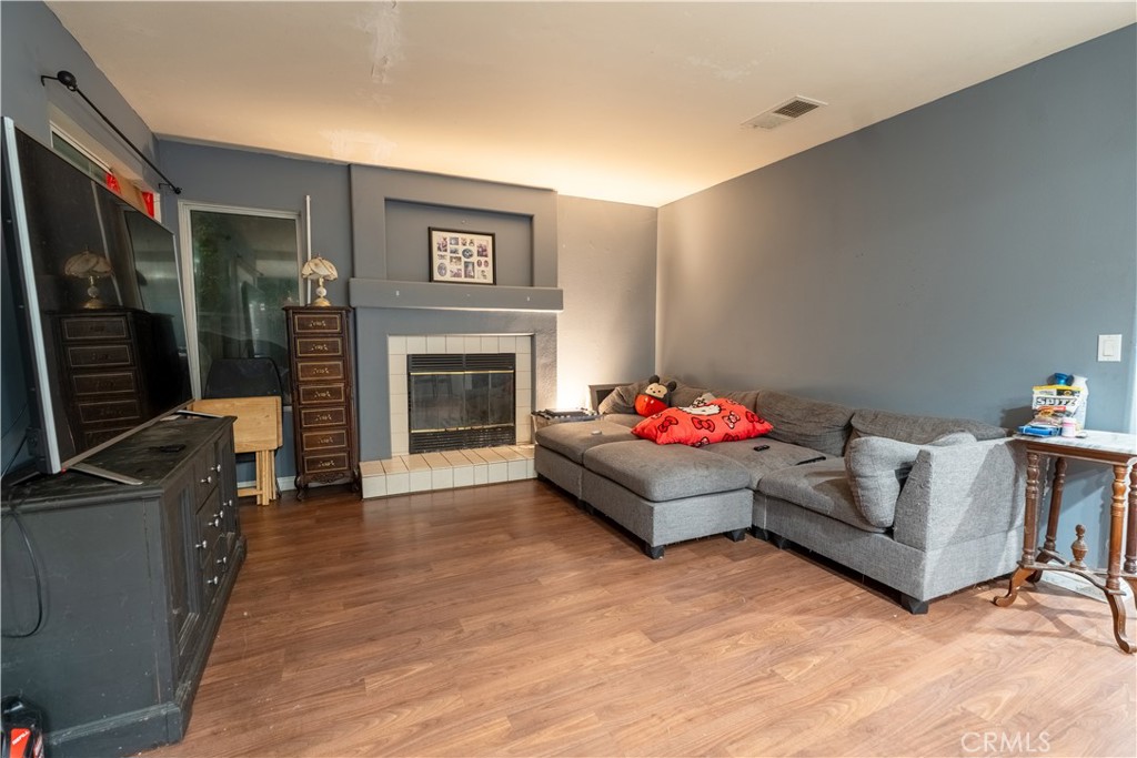 21329 Tennyson Road Moreno Valley, CA 92557 - Photo 8 of 32 a living room with furniture and a fireplace
