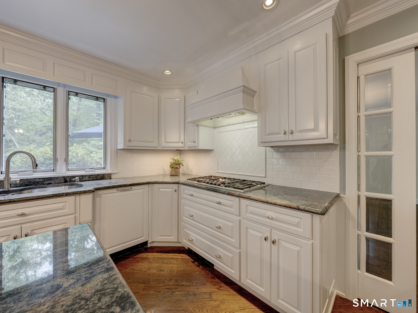 78 Windtree Street Torrington, CT 06790 - Photo 21 of 40 a kitchen with granite countertop white cabinets and window
