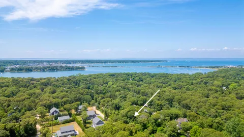 an aerial view of a houses with a yard