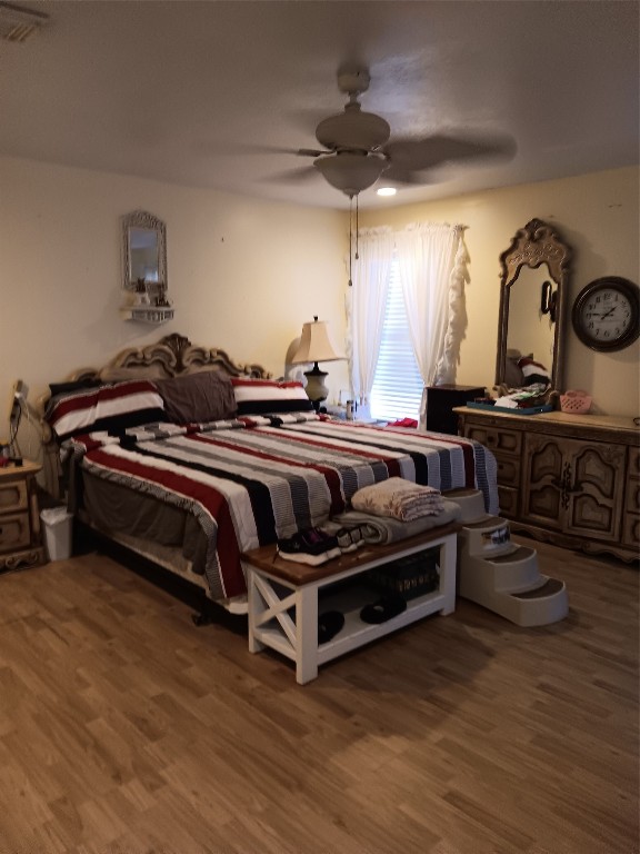 420 Mangum Road Livingston, TX 77351 - Photo 23 of 36 a bedroom with bed and a chandelier