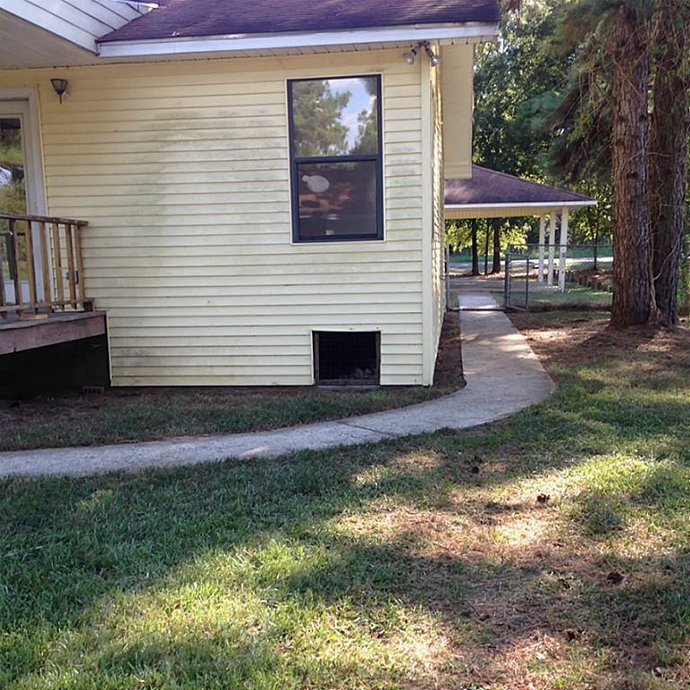 420 Mangum Road Livingston, TX 77351 - Photo 26 of 36 a view of a brick house with a yard