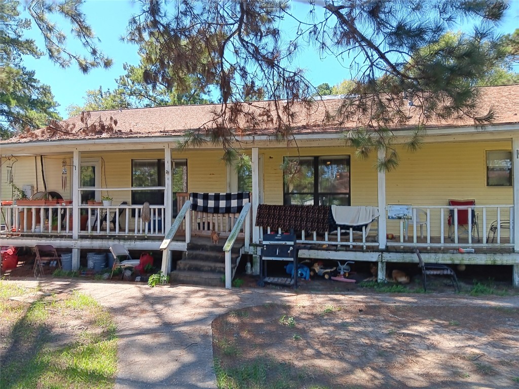 420 Mangum Road Livingston, TX 77351 - Photo 29 of 36 a view of a house with wooden deck and furniture