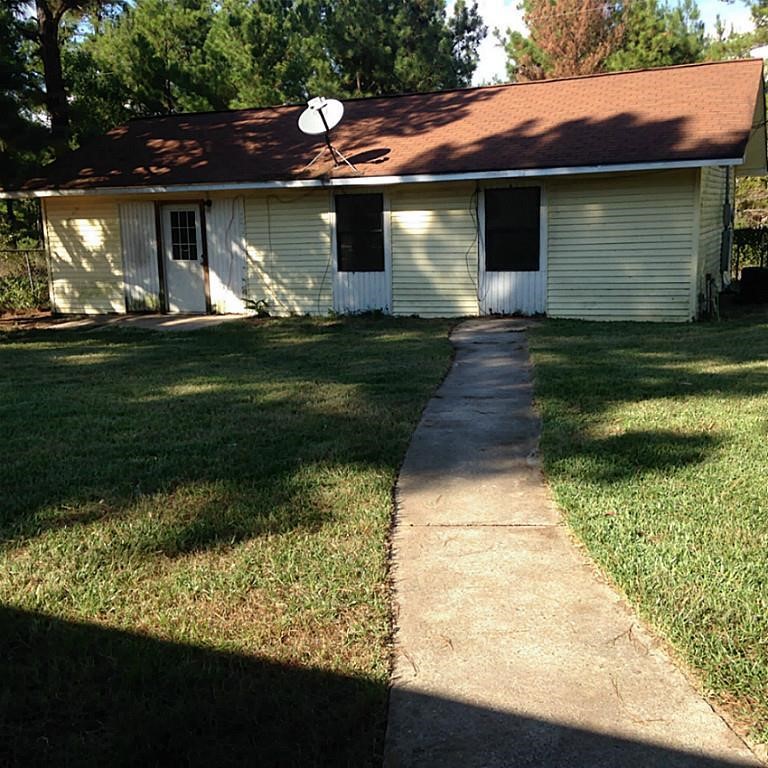 420 Mangum Road Livingston, TX 77351 - Photo 33 of 36 a front view of a house with a yard