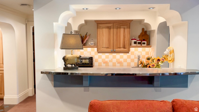 426 West Center Street Parowan, UT 84761 - Photo 65 of 107 Built-in pass-through serving counter featuring a metal finish countertop and a checkered tile backsplash